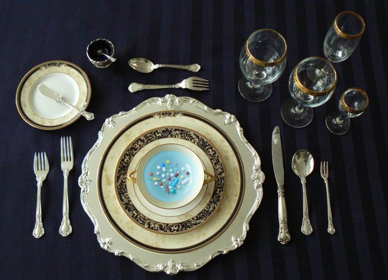 Formal table setting with a plate of pills served as a meal