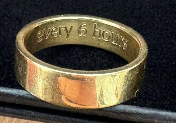 Gold wedding ring engraved on the inside with the words every 6 hours