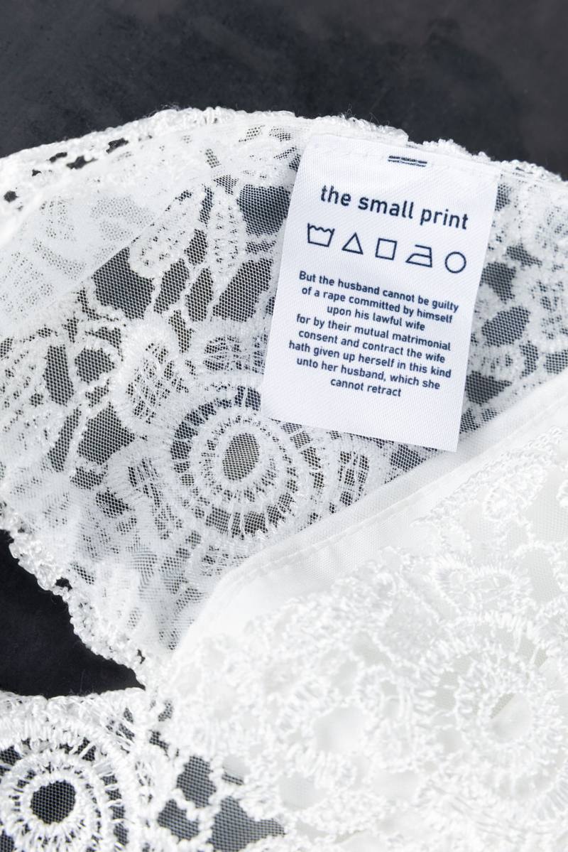 Close-up detail of the small print care label on a wedding dress