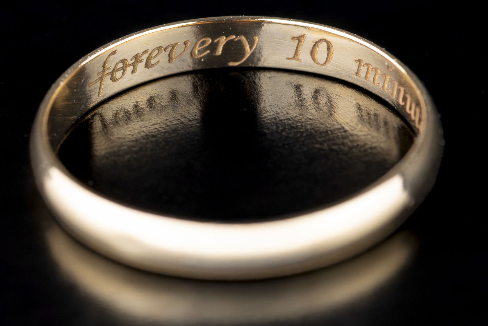 Wedding ring engraved Every 10 Minutes, shown in its jewellery box