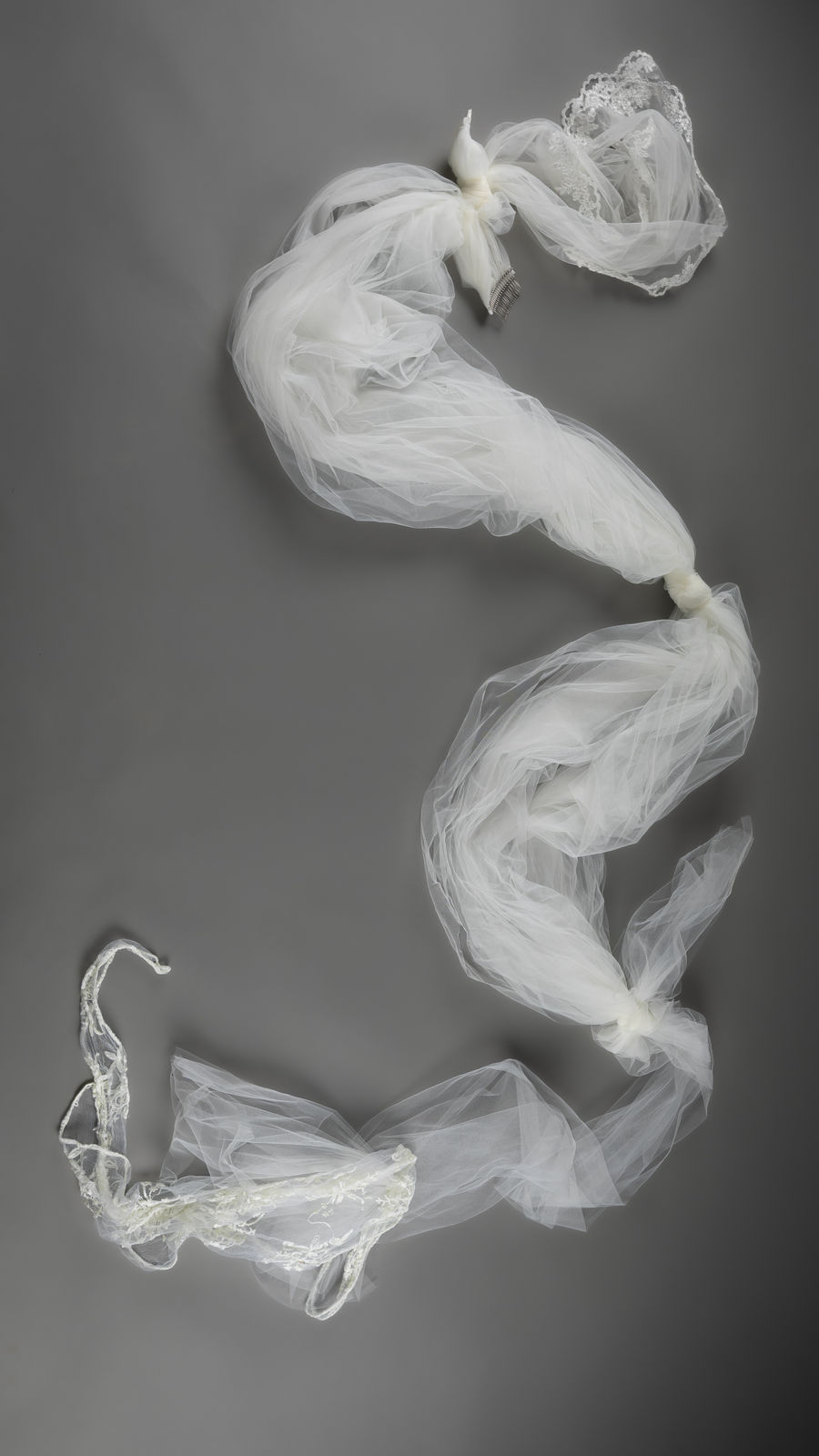 Detail of bridal veil fabric tied together like an escape rope